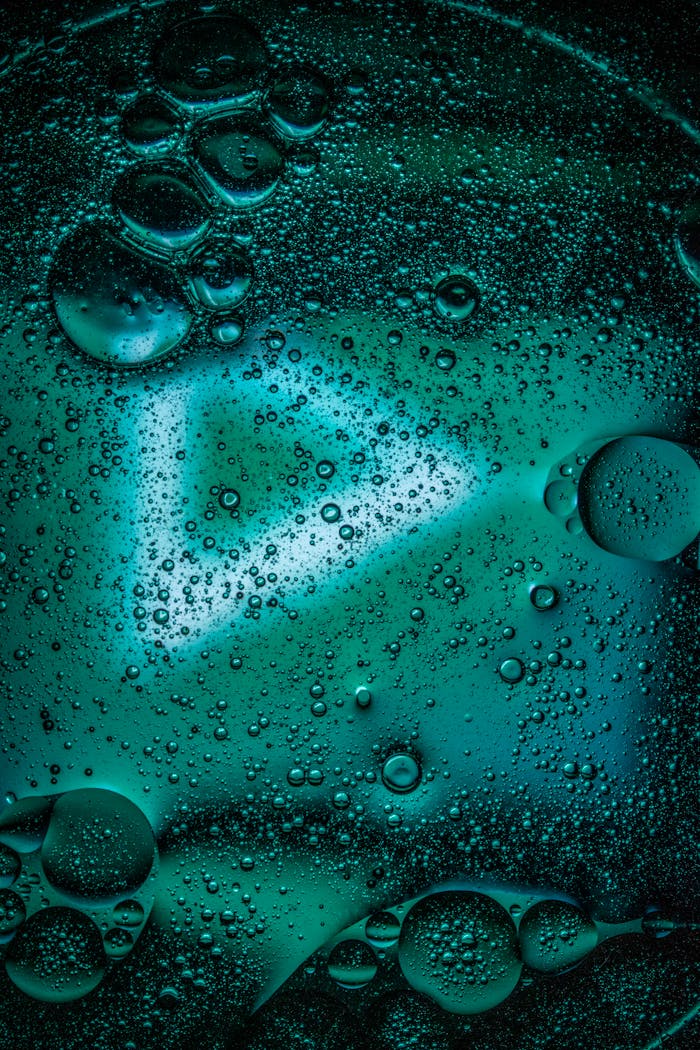 Captivating close-up of bubbles in liquid with vibrant colors and texture.