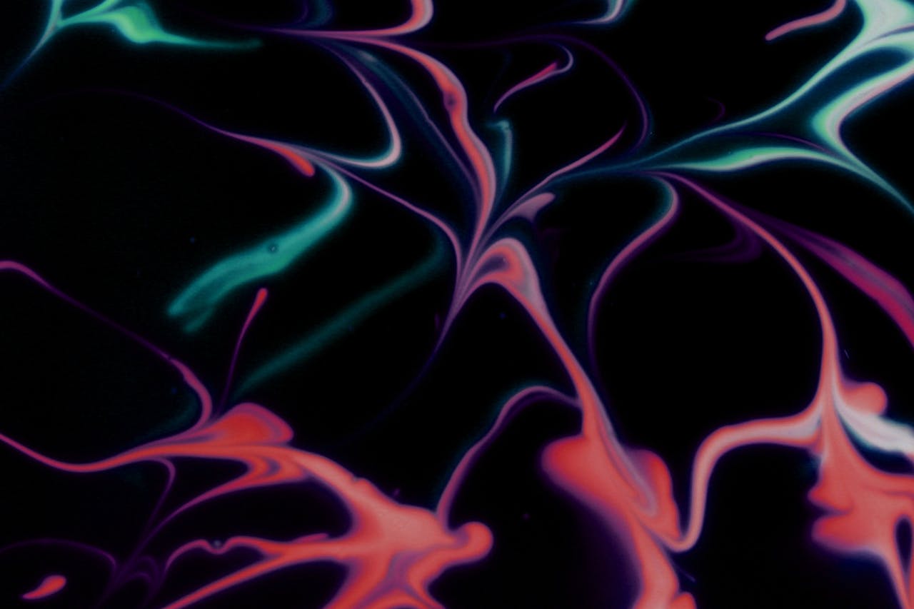 Services Colorful swirls of abstract fluid art create a vibrant contrast on a dark background.