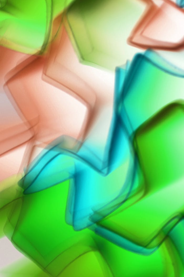 Vibrant abstract image of overlapping geometric shapes in green, blue, and orange hues.